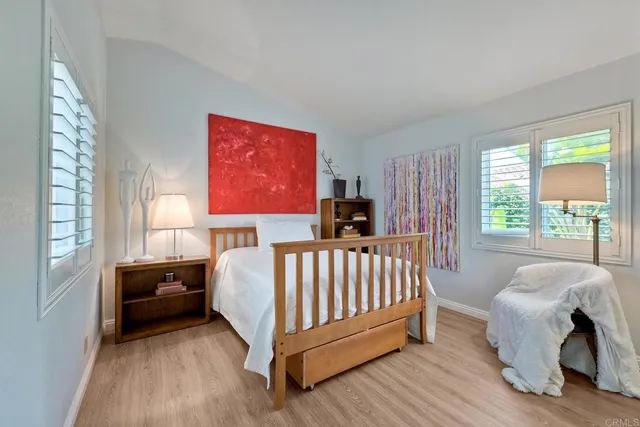 a bed room with a bed and a chair