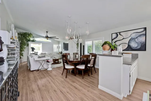 a view of a dining room with furniture and chandelier