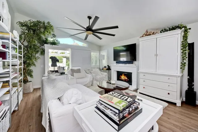 a living room with furniture a fireplace and a flat screen tv