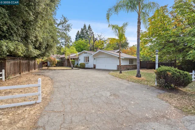 a view of a house with a yard and garage