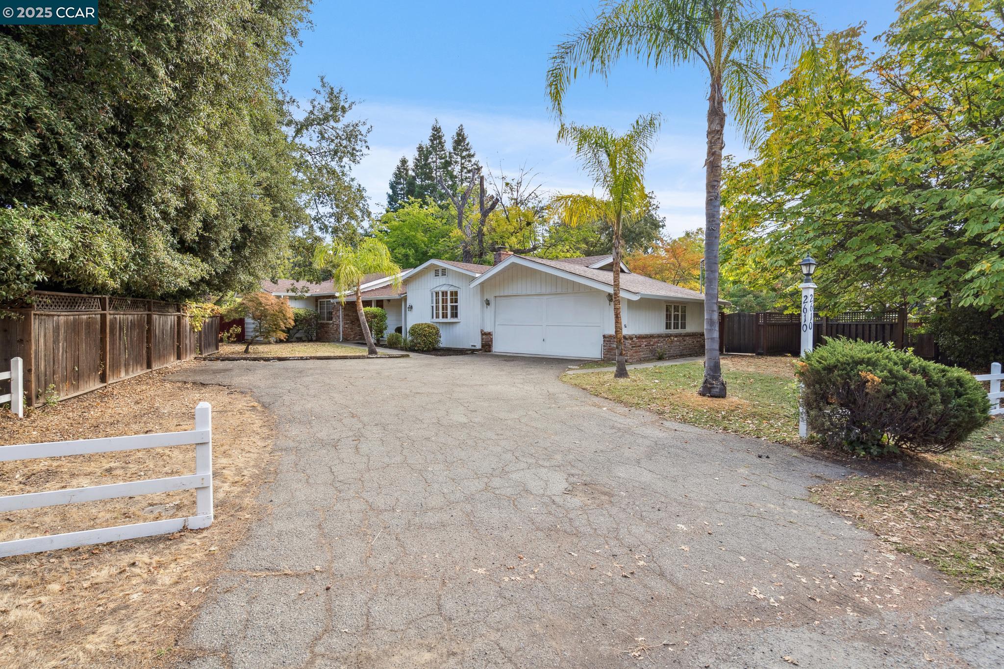 a view of a house with a yard and garage
