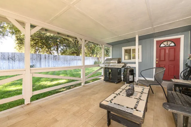 a living room with furniture and a floor to ceiling window