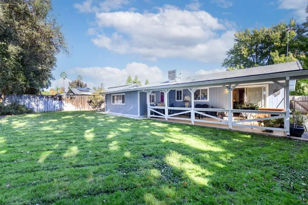 a view of a house with backyard porch and sitting area