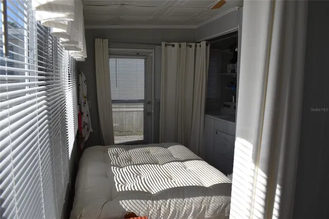 a bedroom with a bed and a window