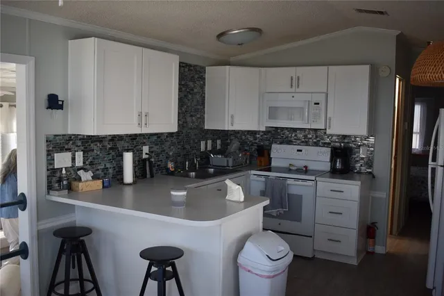 a kitchen with stainless steel appliances a sink a stove and cabinets