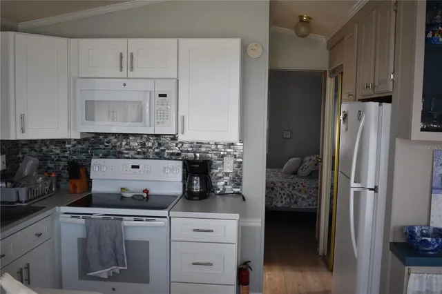 a kitchen with stainless steel appliances granite countertop a refrigerator sink and stove