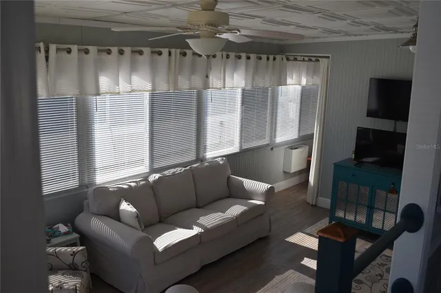 a living room with furniture and a glass door