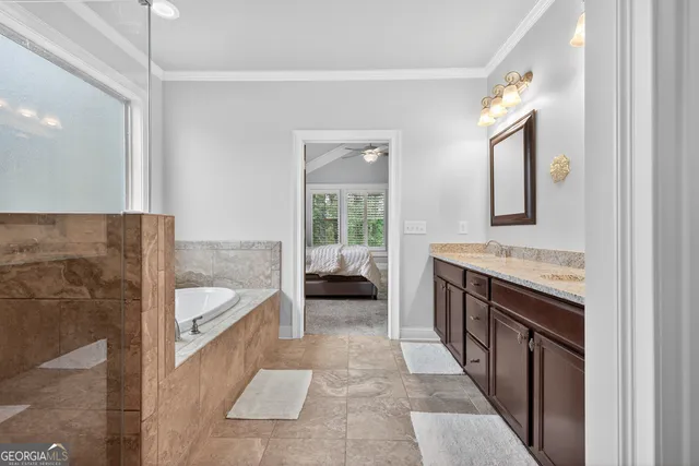 a bathroom with a sink a toilet a window and vanity