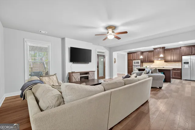 a balcony with wooden floor table and chairs