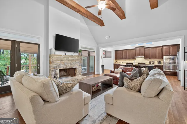 a living room with fireplace furniture and a wooden floor