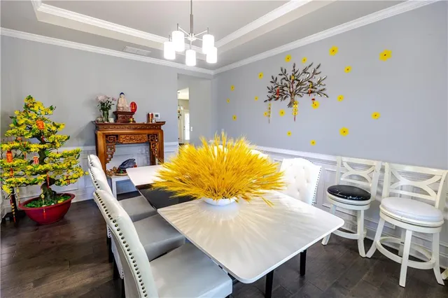 a view of a dining room with furniture and chandelier