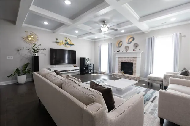 a living room with furniture a fireplace and a flat screen tv
