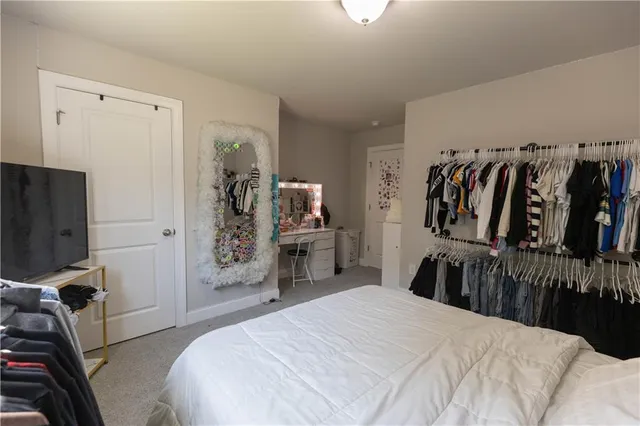 a bedroom with a bed and a tv