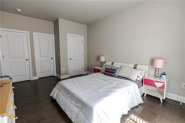 a bedroom with a bed and a lamp