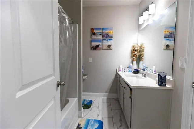 a bathroom with a sink a mirror and a shower