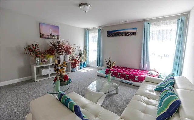 a living room with furniture and flowers