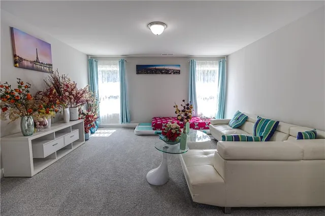 a living room with furniture and flowers