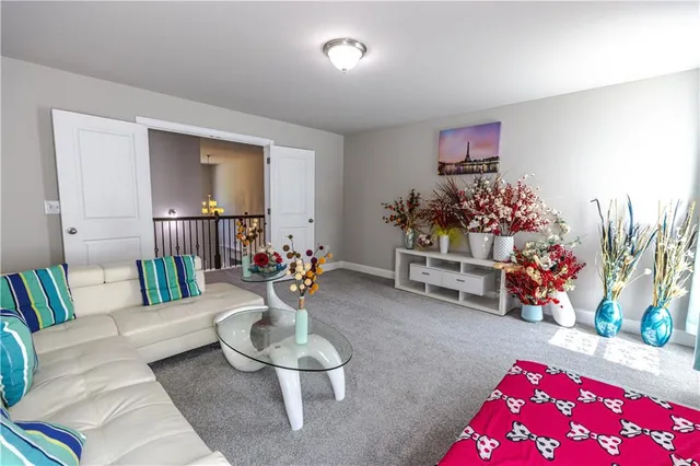 a living room with furniture and flowers