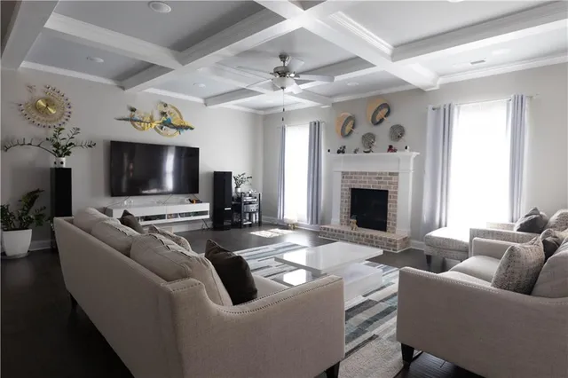 a living room with furniture a fireplace and a flat screen tv