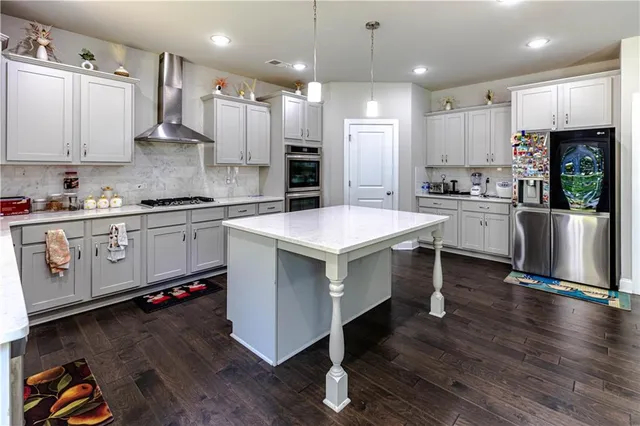 a kitchen with a white wooden cabinets stainless steel appliances and a window