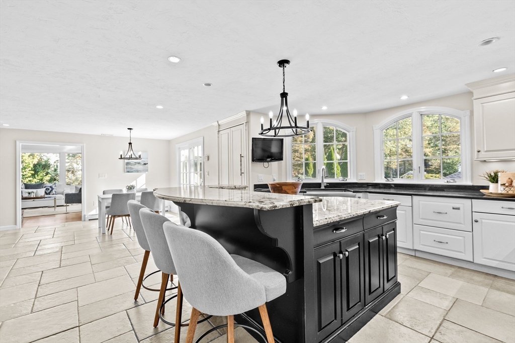 2 Windward Lane Scituate, MA 02066 - Photo 17 of 42 a kitchen with stainless steel appliances kitchen island granite countertop a sink and cabinets