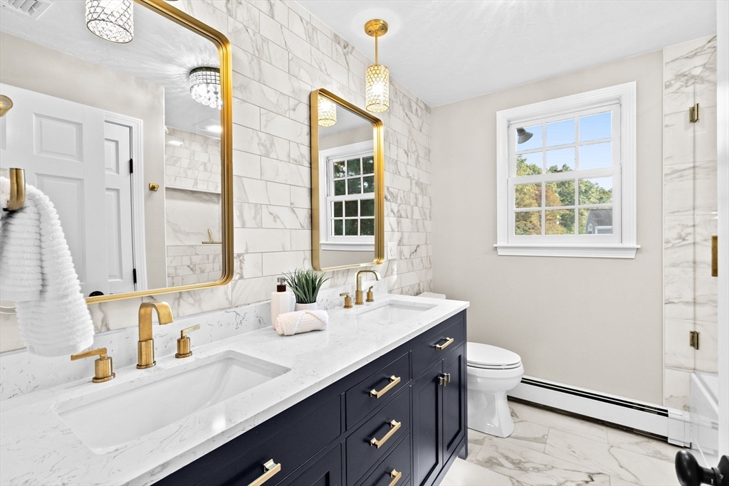2 Windward Lane Scituate, MA 02066 - Photo 21 of 42 a bathroom with double vanity sink a mirror and a toilet