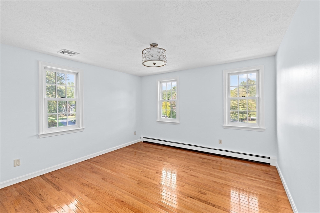 2 Windward Lane Scituate, MA 02066 - Photo 25 of 42 a view of an empty room with window and wooden floor