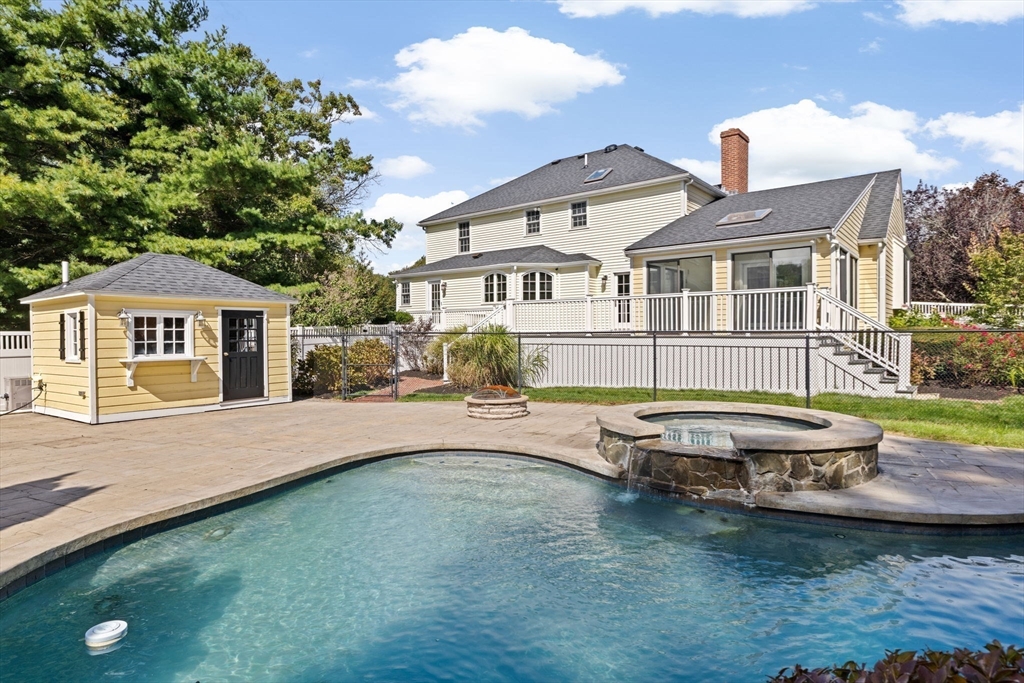 2 Windward Lane Scituate, MA 02066 - Photo 8 of 42 a front view of a house with a garden and lake view