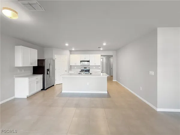 a view of a kitchen with microwave and cabinets