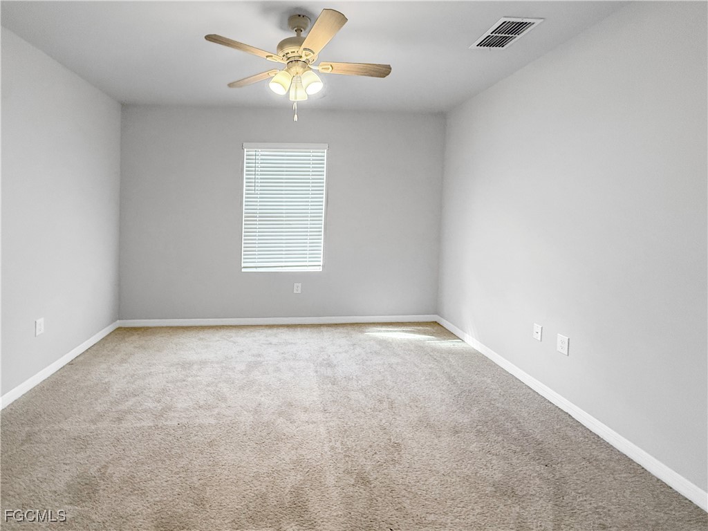 8357 Matanzas Road Fort Myers, FL 33967 - Photo 7 of 25 an empty room with a window and a ceiling fan