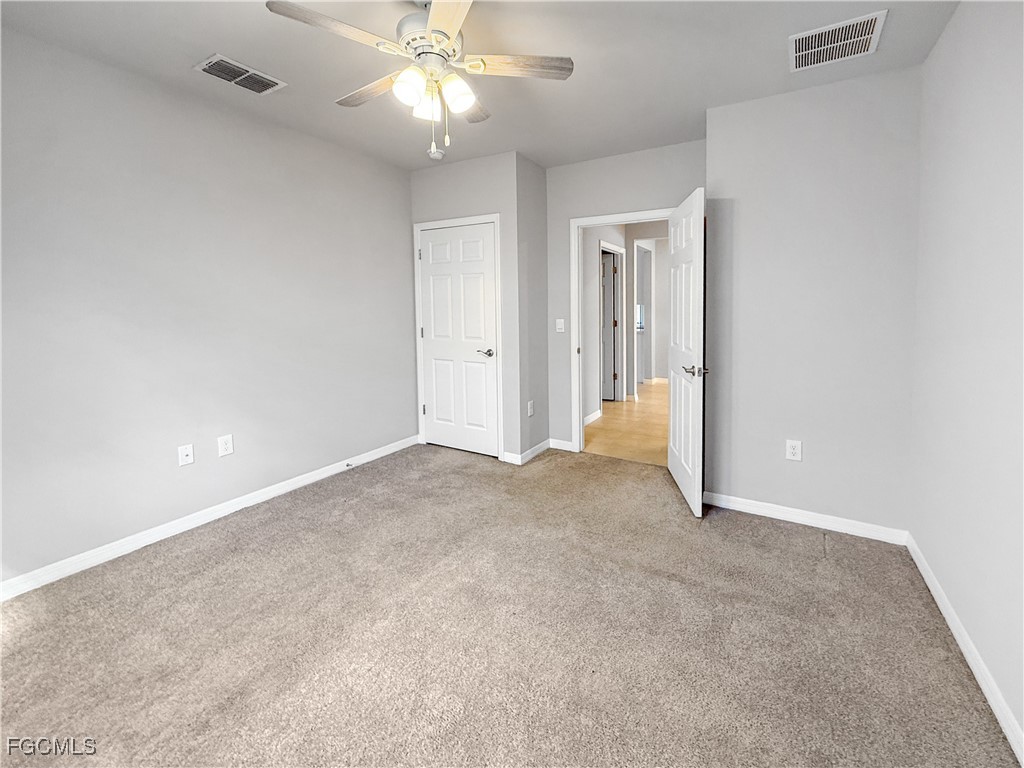 8357 Matanzas Road Fort Myers, FL 33967 - Photo 8 of 25 a view of an empty room and a chandelier fan