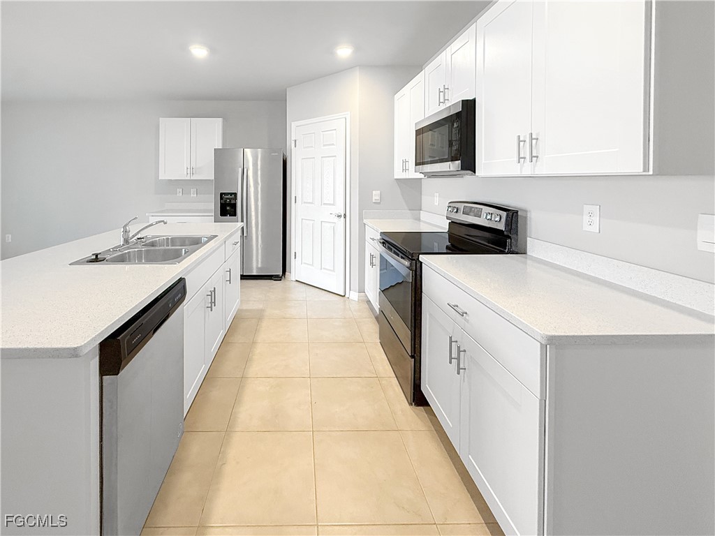 8357 Matanzas Road Fort Myers, FL 33967 - Photo 10 of 25 a kitchen with a sink stove top oven and refrigerator