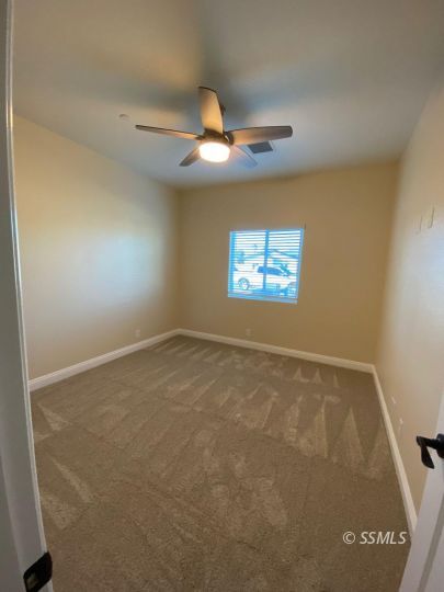 1046 Ocean Avenue Ridgecrest, CA 93555 - Photo 11 of 19 an empty room with windows and fan