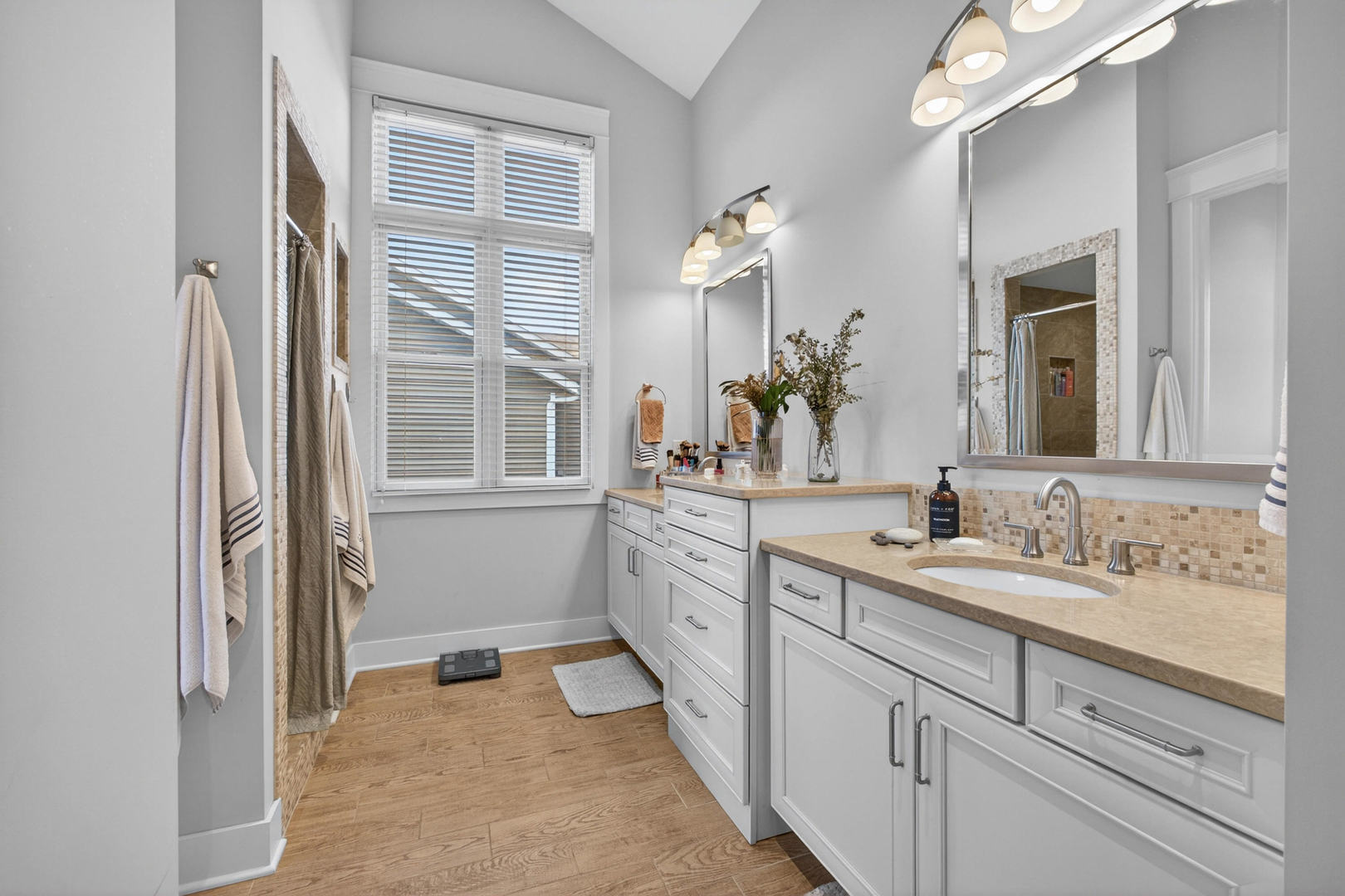 5700 Emily Road Bettendorf, IA 52722 - Photo 36 of 58 a spacious bathroom with a double vanity sink a mirror a and a window