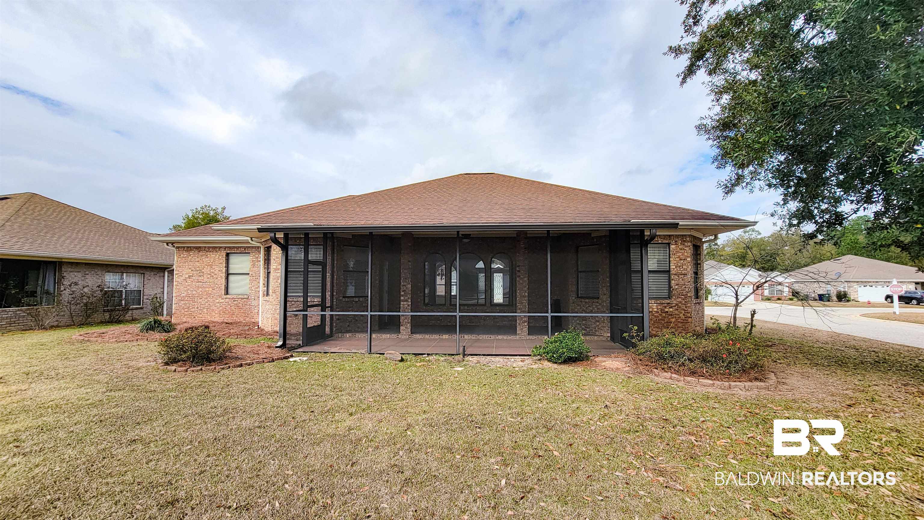 214 Hemingway Loop Foley, AL 36535 - Photo 39 of 67 Back of property with a yard, brick siding, a sunroom, and roof with shingles