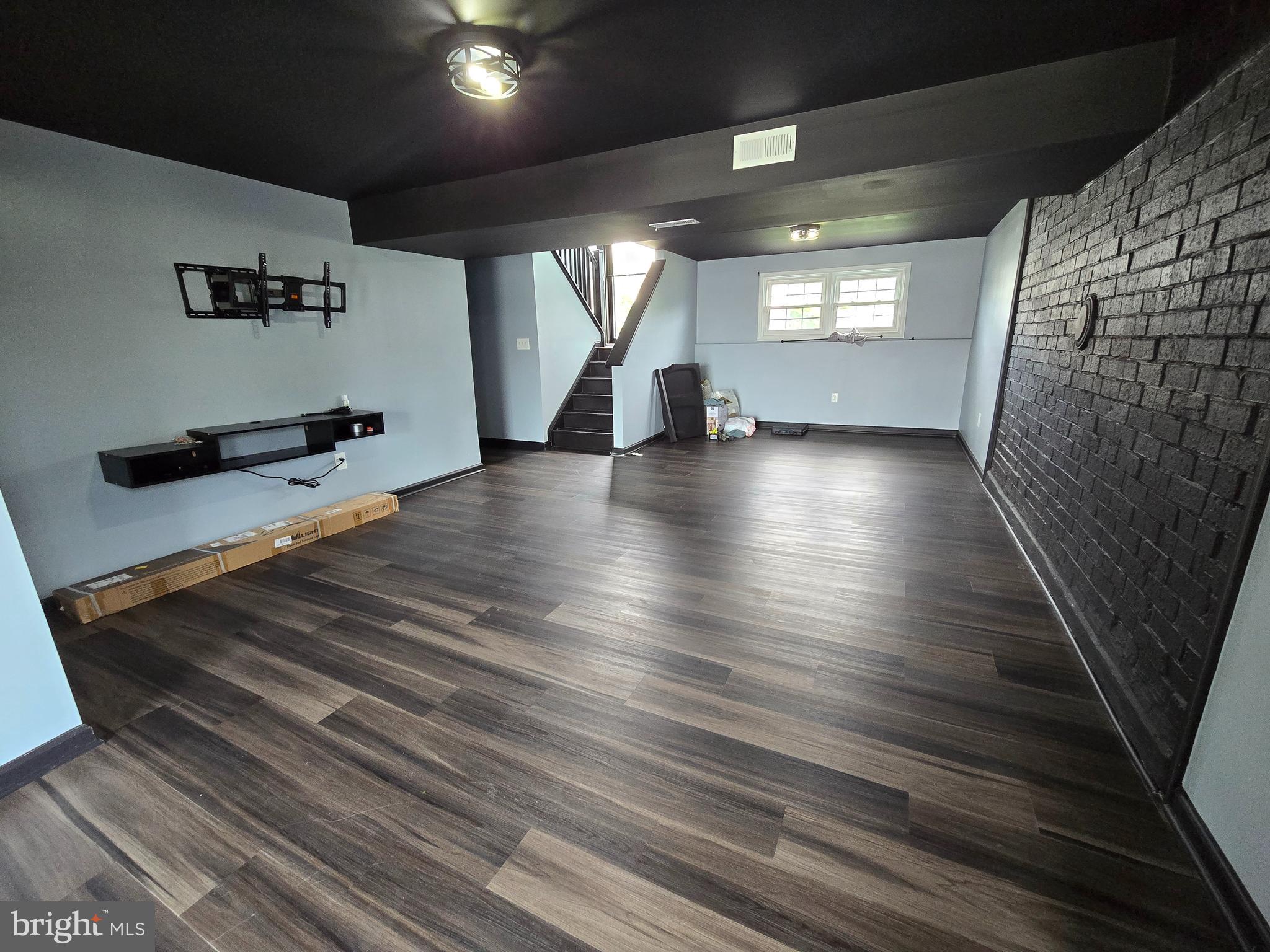 7513 Saffron Court Hanover, MD 21076 - Photo 32 of 42 an empty room with wooden floor and windows