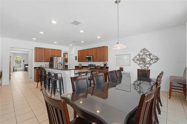 a large kitchen with a table and chairs