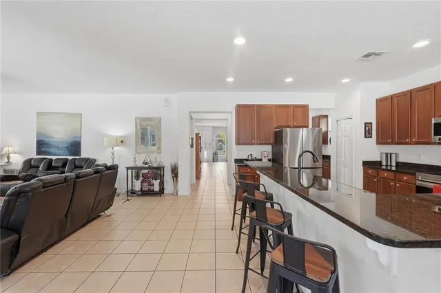 a kitchen with stainless steel appliances kitchen island granite countertop a sink and cabinets