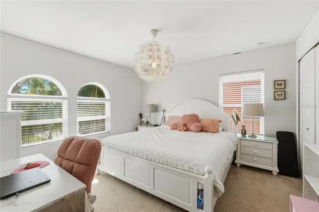 a bedroom with a bed chair and window