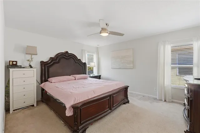 a spacious bedroom with a bed and a dresser