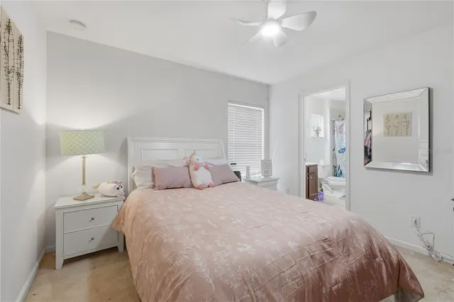 a bedroom with a bed and a night stand