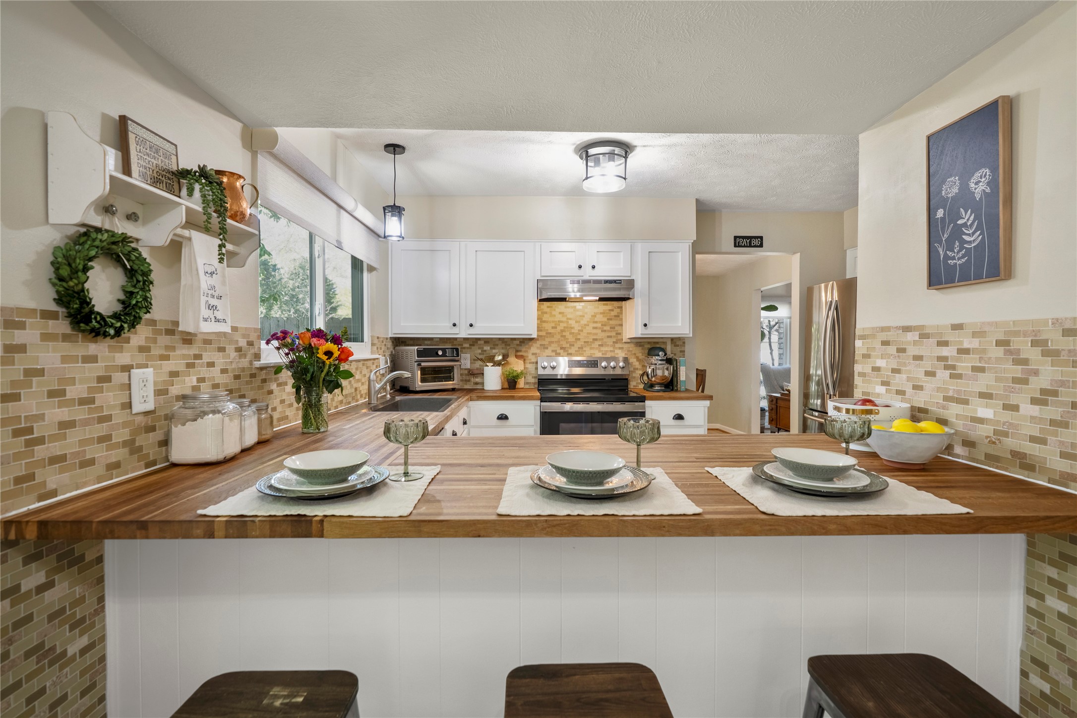 12224 Gun Oak Place Spring, TX 77380 - Photo 13 of 42 Thoughtfully designed kitchen with butcher block surfaces, upgraded soft-close cabinets and drawers, and a new oven, offering a seamless flow ideal for both daily routines and hosting.