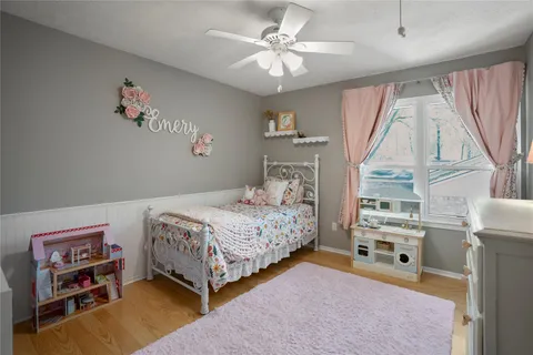 a bedroom with a bed a couch and a large window