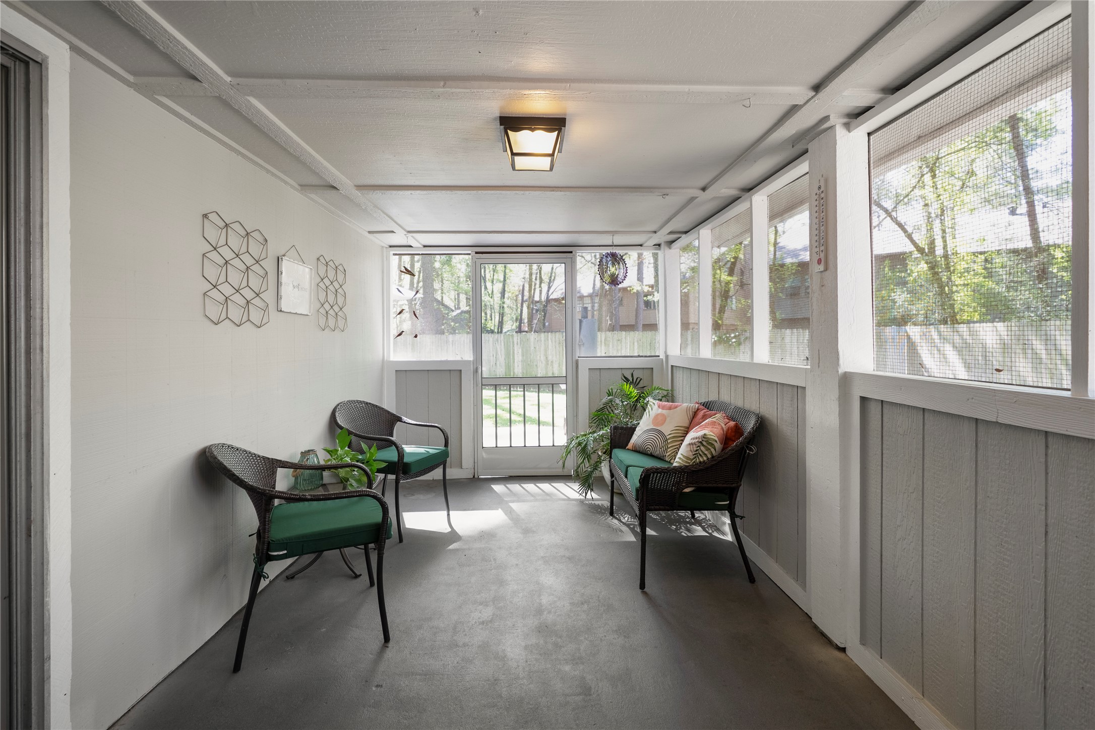 12224 Gun Oak Place Spring, TX 77380 - Photo 30 of 42 A standout feature—this screened-in porch offers a peaceful extension of the home, perfect for morning coffee or unwinding in the evenings.
