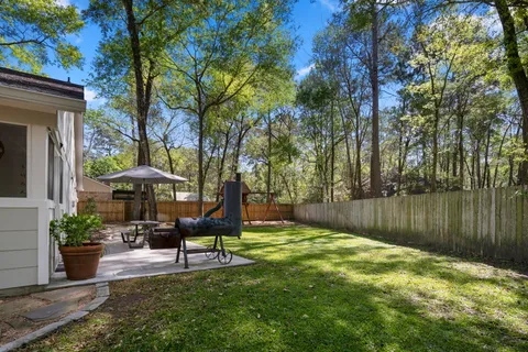 a swimming pool with outdoor seating and yard