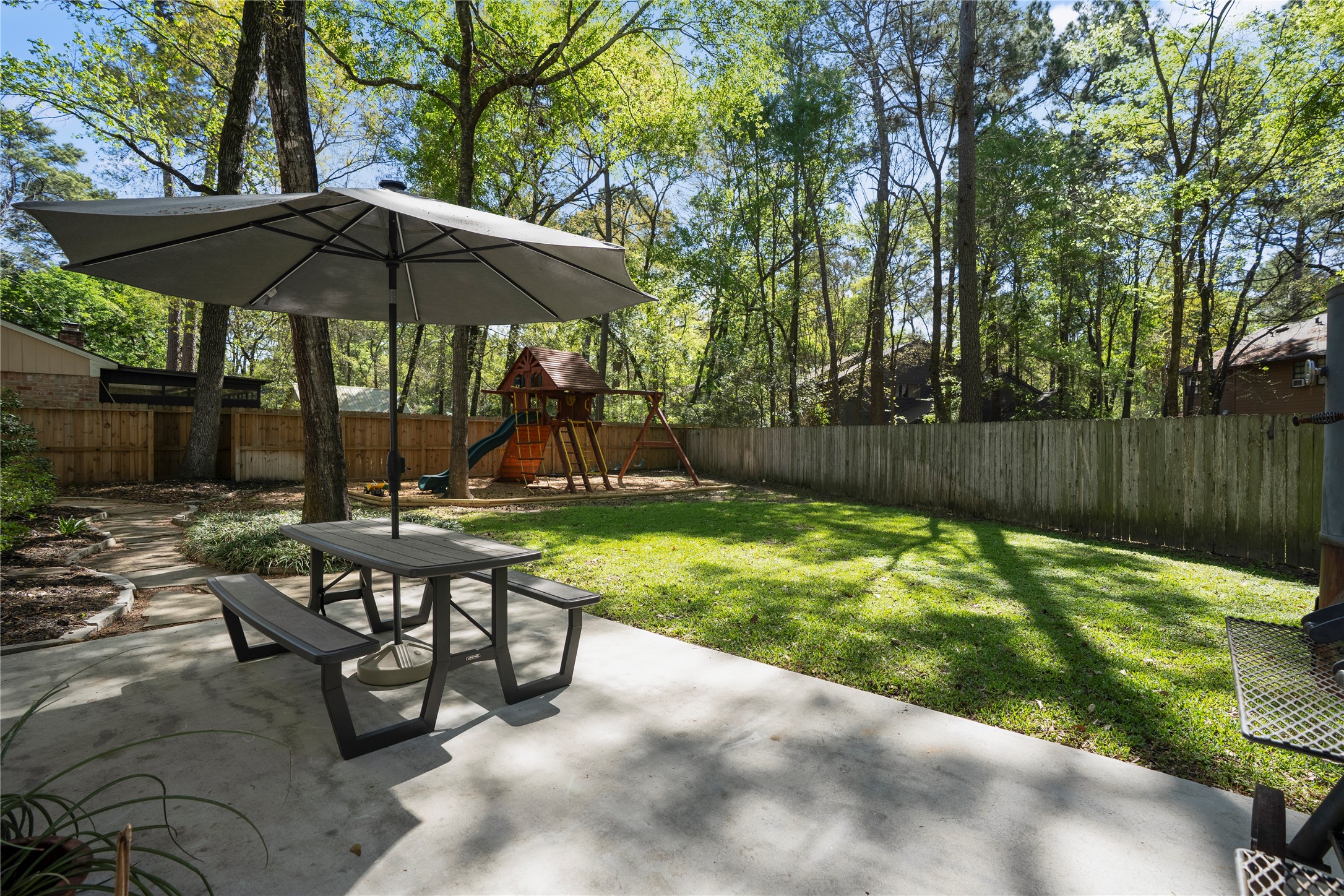 12224 Gun Oak Place Spring, TX 77380 - Photo 33 of 42 Outdoor patio area ideal for gathering, dining, or simply enjoying the surrounding nature.
