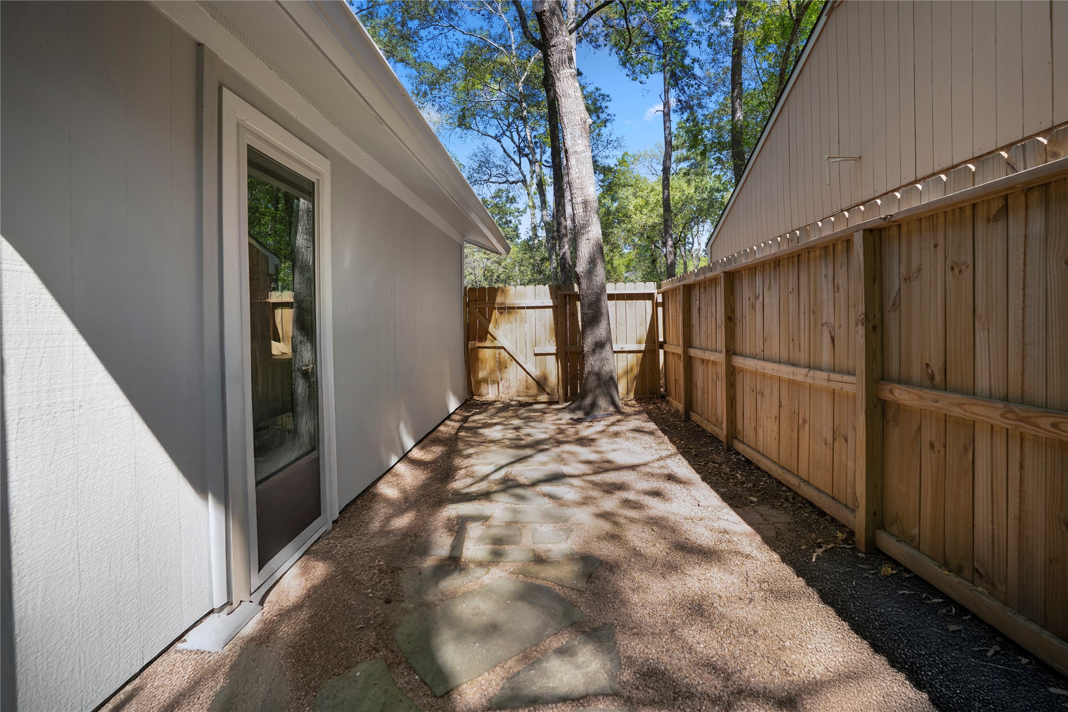 12224 Gun Oak Place Spring, TX 77380 - Photo 39 of 42 Extended side yard space with privacy fencing, creating a quiet and usable outdoor environment.