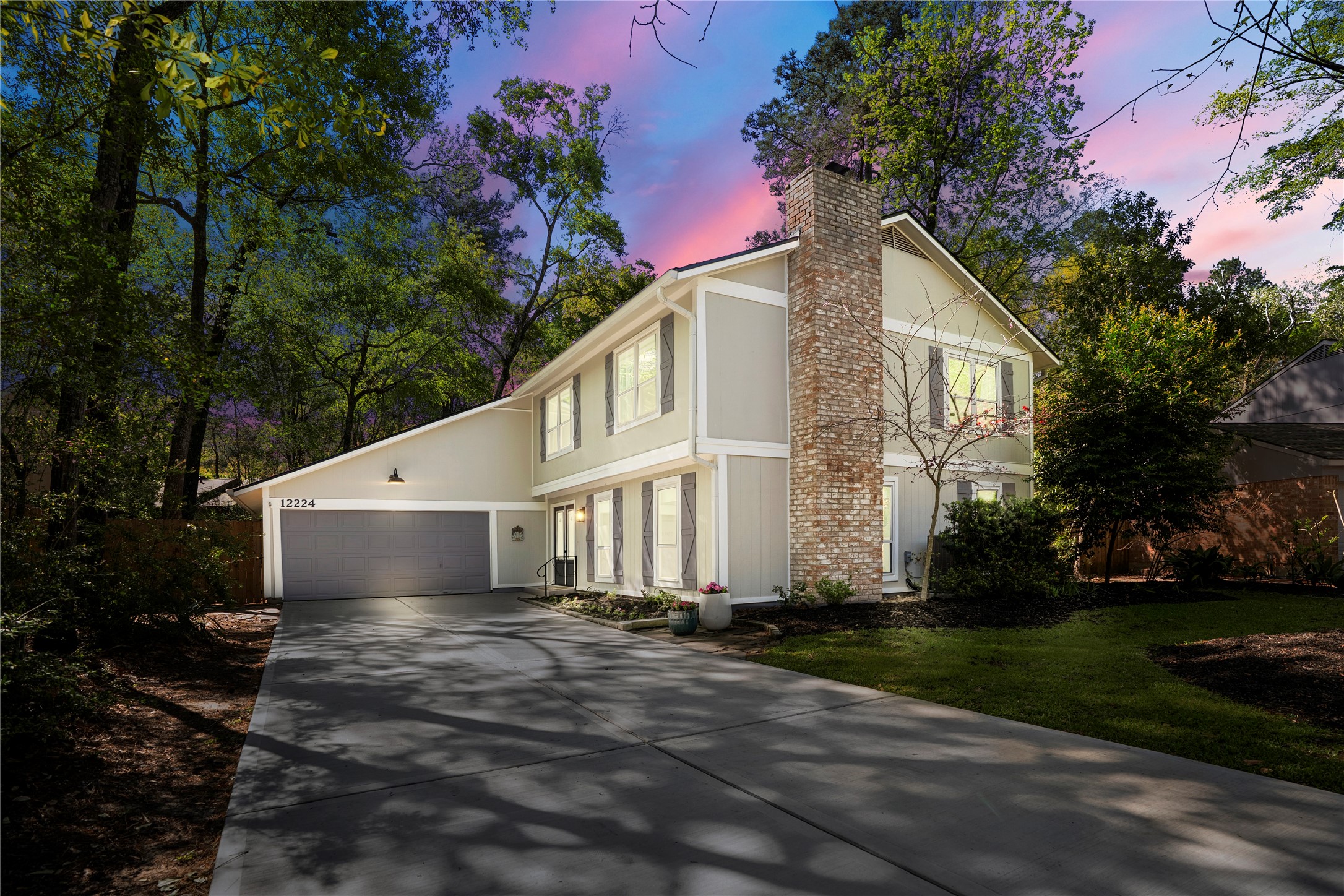 12224 Gun Oak Place Spring, TX 77380 - Photo 42 of 42 Beautifully set beneath mature trees, this home truly shines in the evening with soft exterior lighting and a peaceful, inviting presence at dusk.