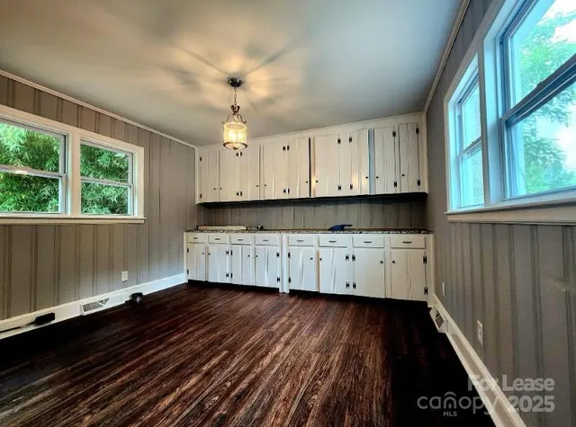 a view of kitchen with wooden floor and window