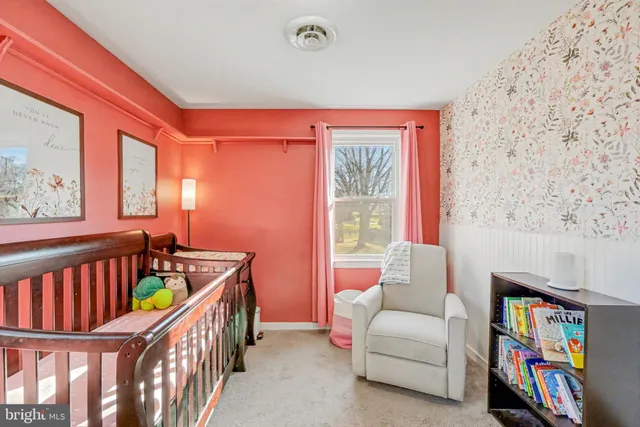 a view of a bedroom with a bookshelf and a book shelf